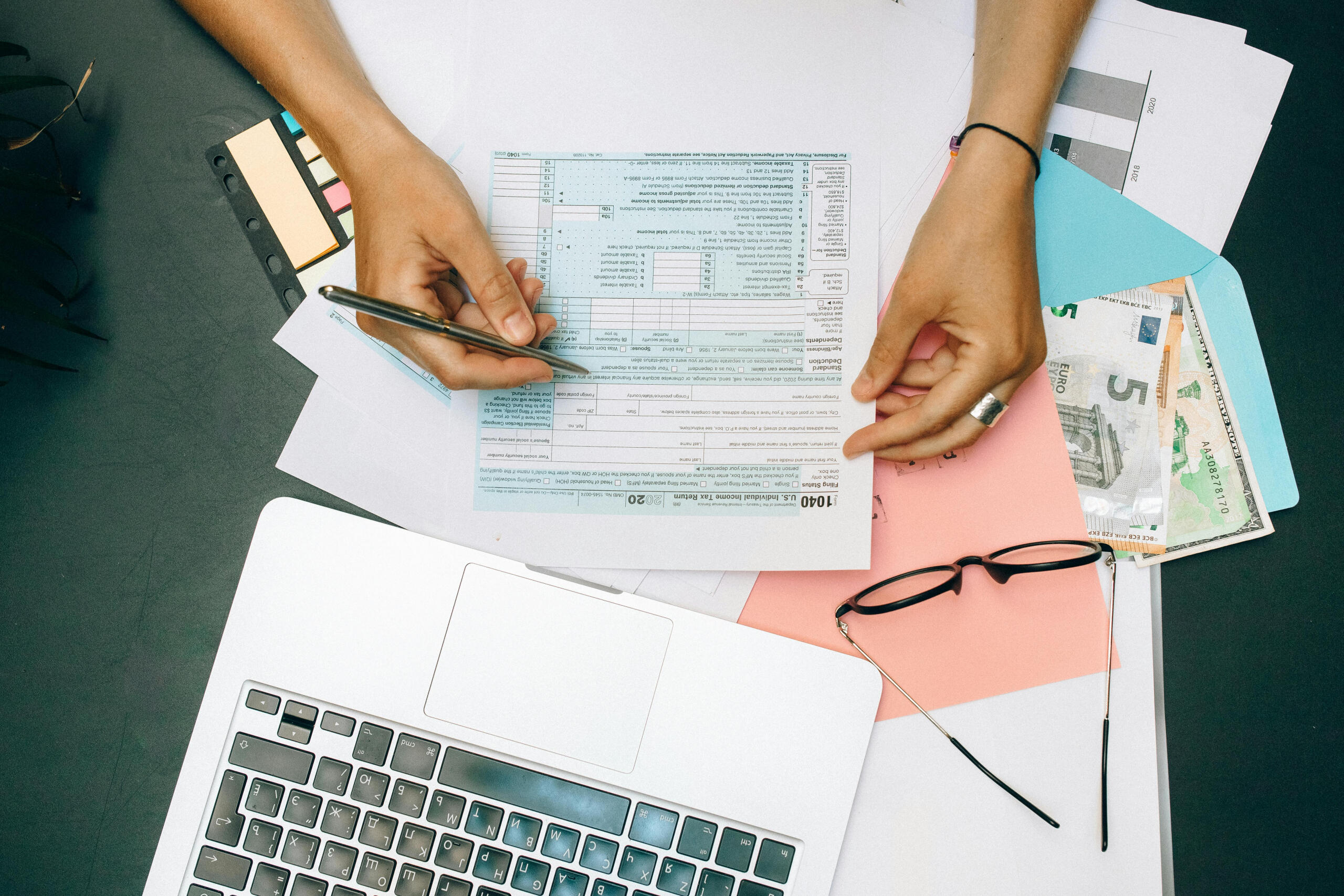Person handling documents on a desk.