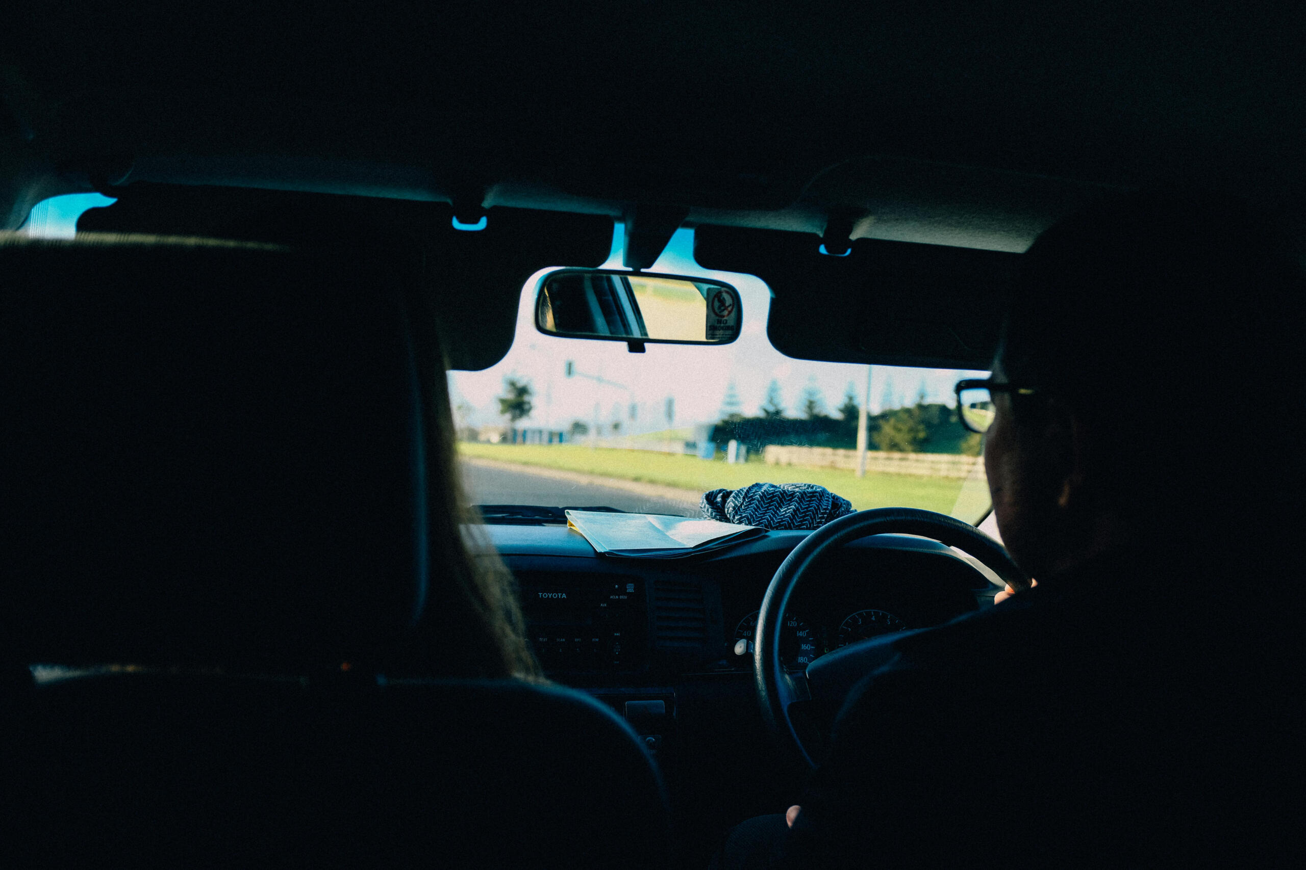 People riding in a right-hand drive car.