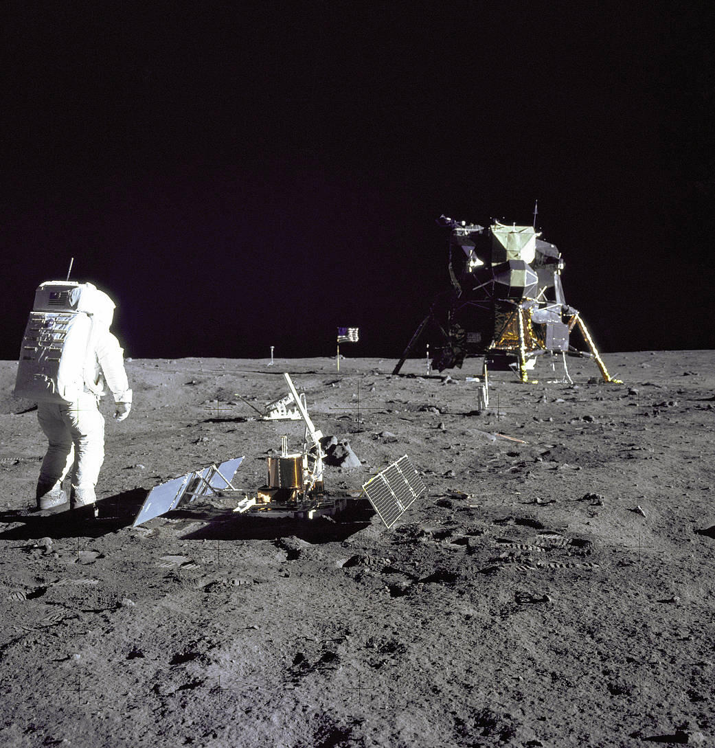 A photo of Buzz Aldrin on the moon looking at the Lunar Module.