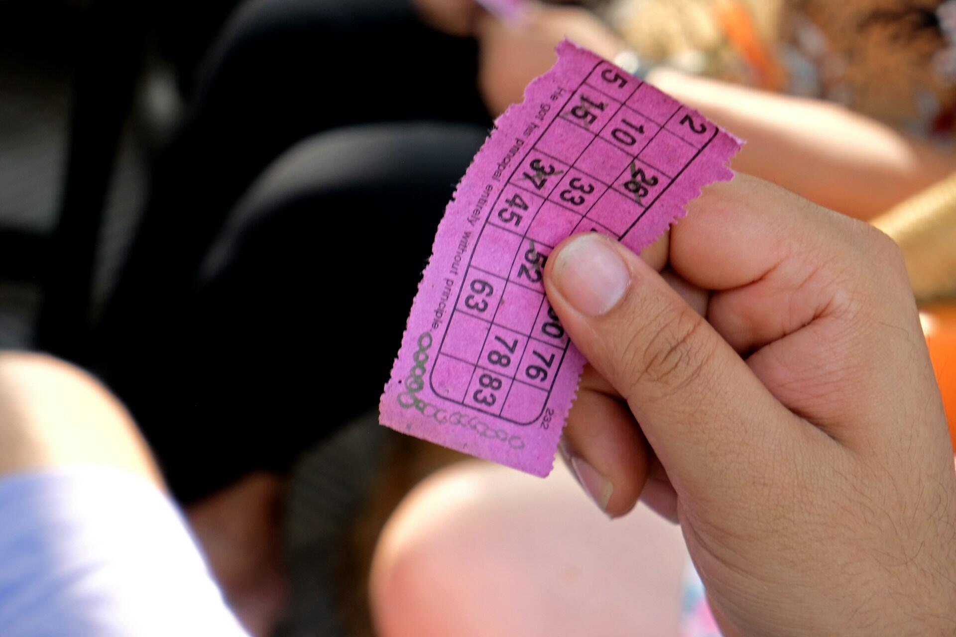 A person holding a bingo sheet.