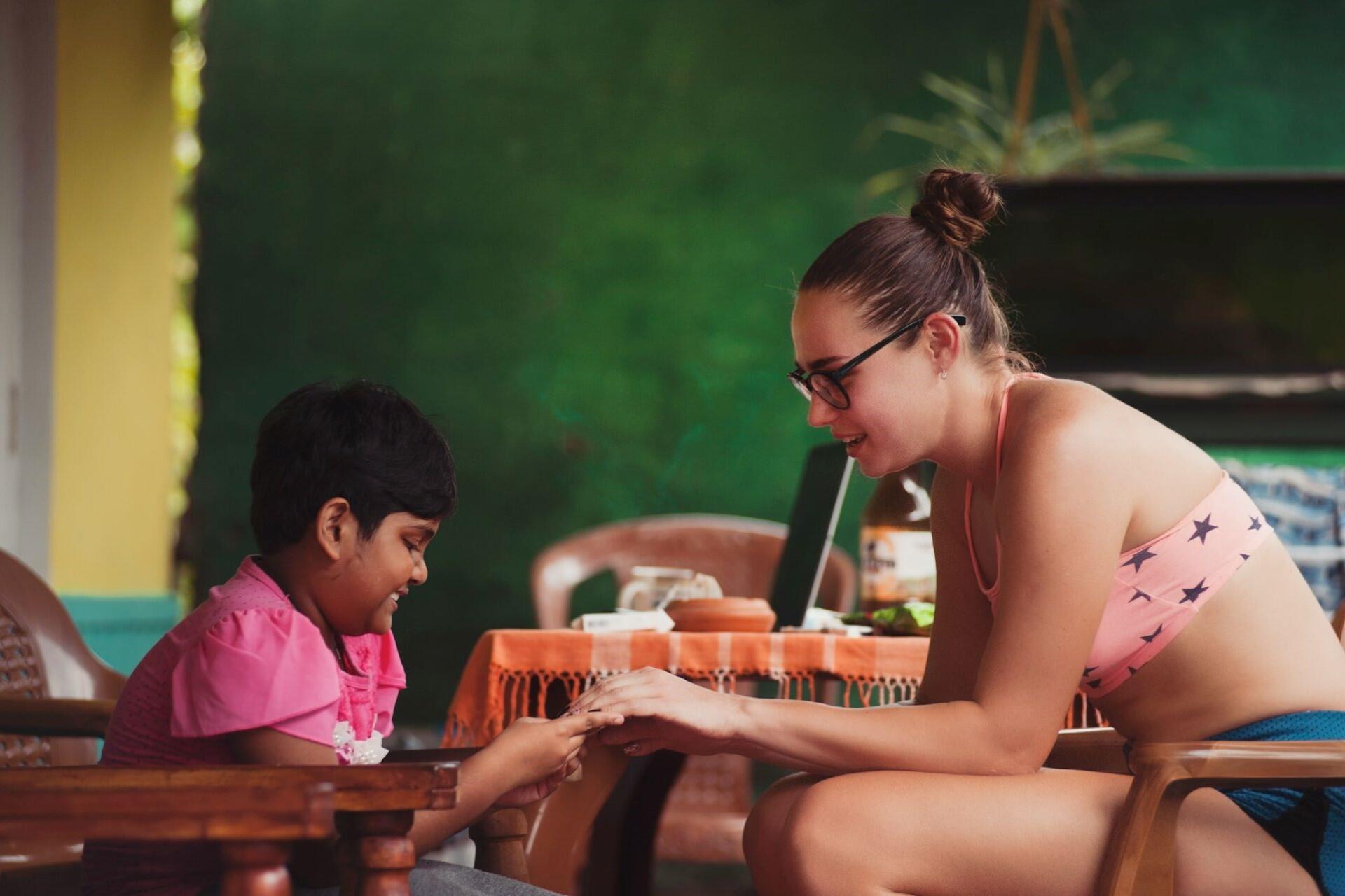 A teacher working with a young student.