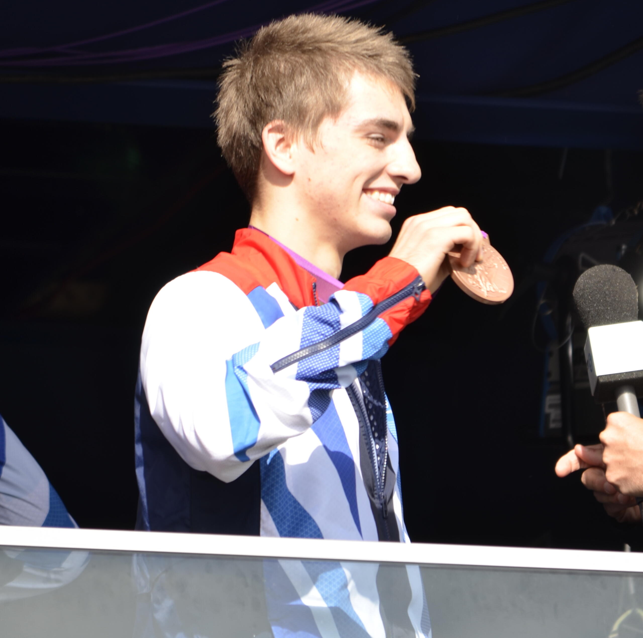 Max Whitlock holding his gymnastics medal in 2012.