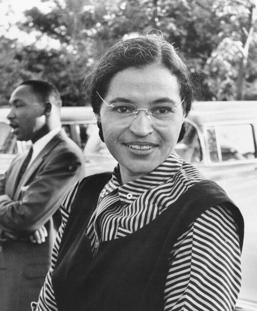 Rosa Parks in the foreground with MLK in the background