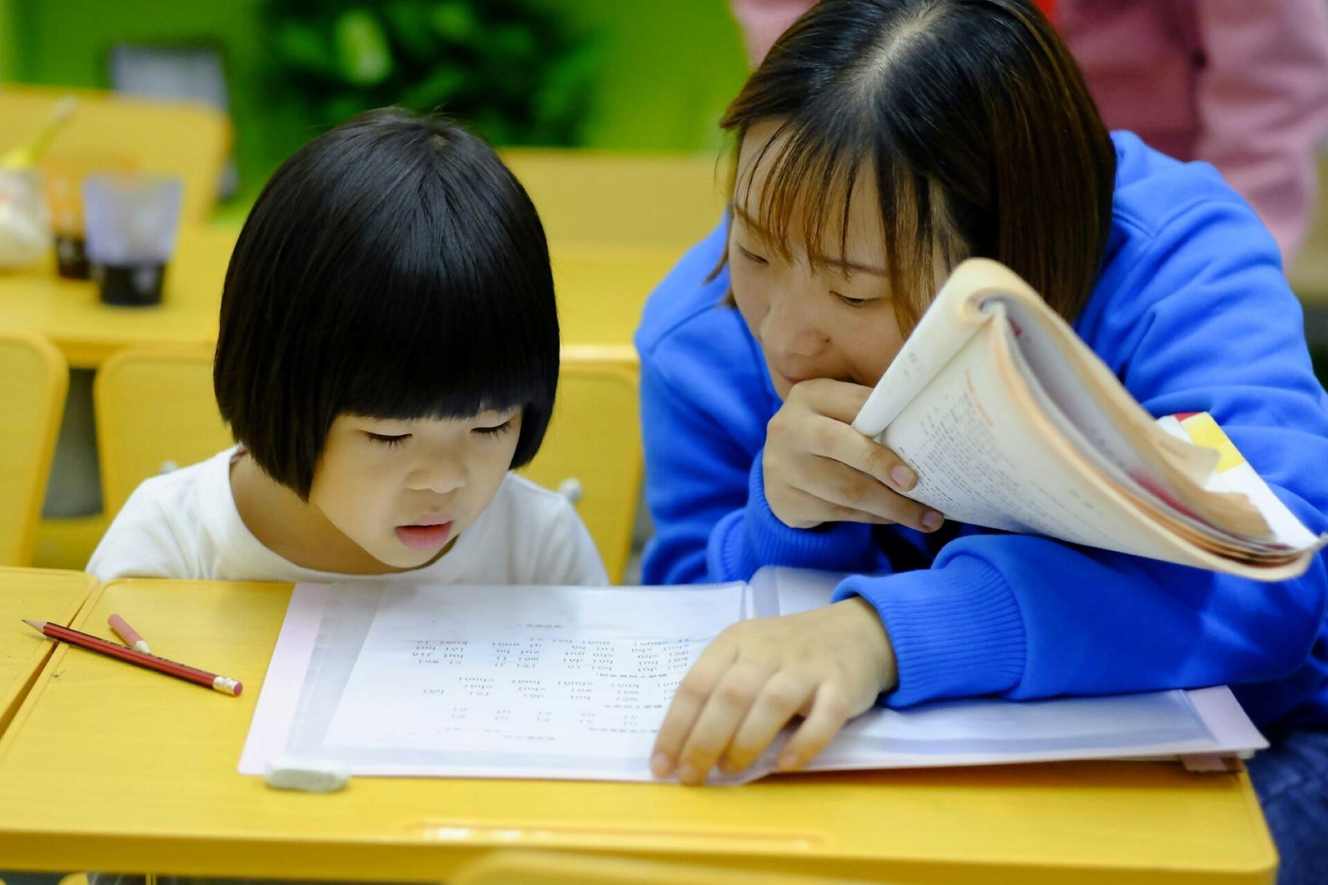 A teacher working with a student.