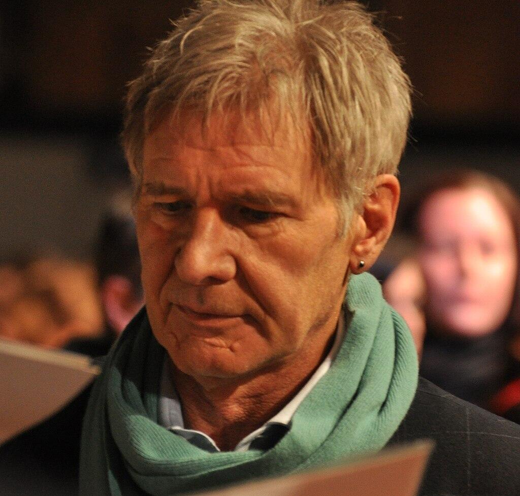 Harrison Ford wearing a green scarf.