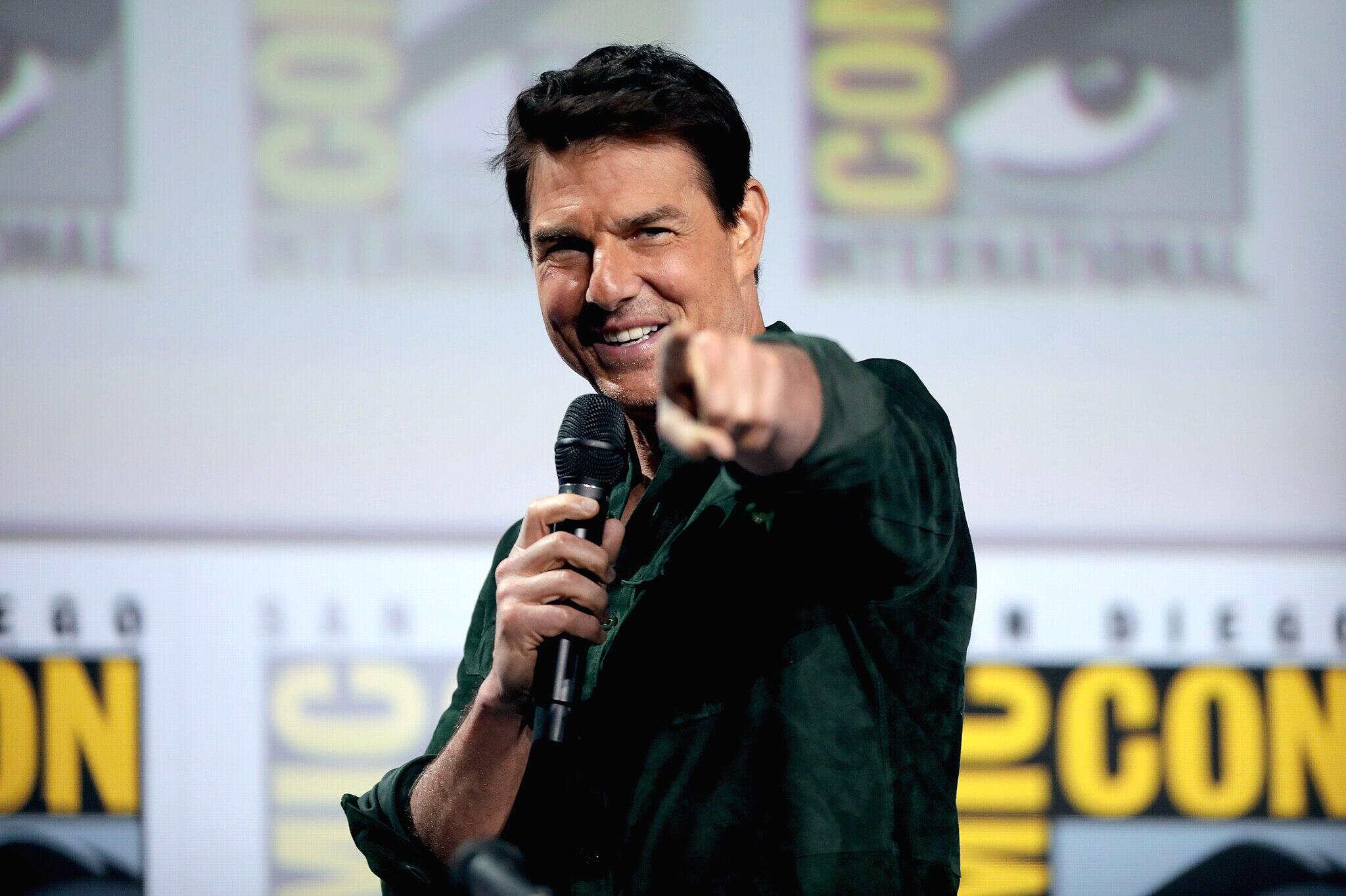 Tom Cruise pointing to a camera