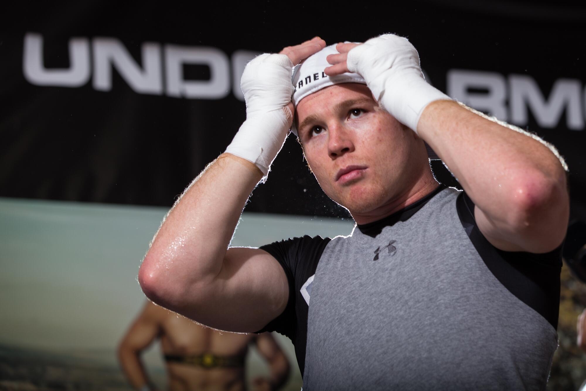 Canelo Alvarez with boxing wraps on.