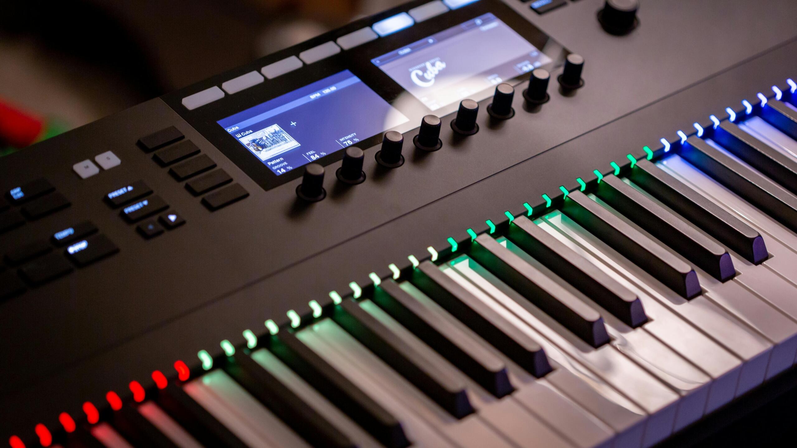 Electronic keyboard with illuminated keys in a studio setting