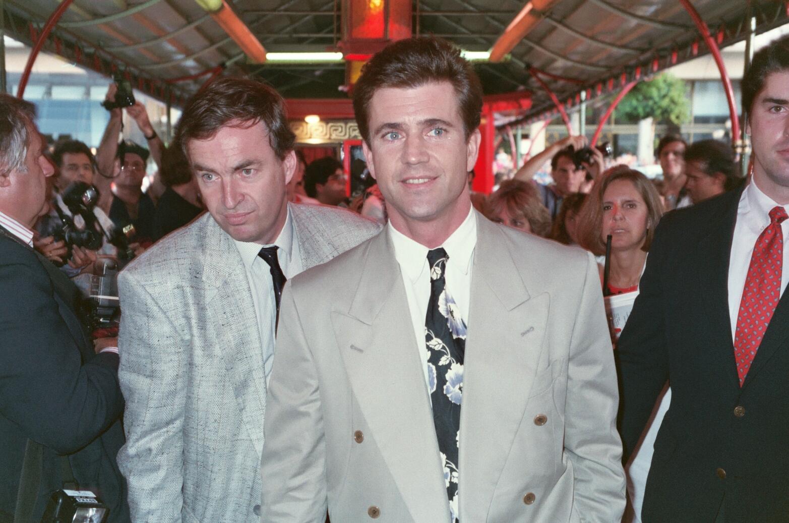 Mel Gibson wearing a suit and a floral tie.