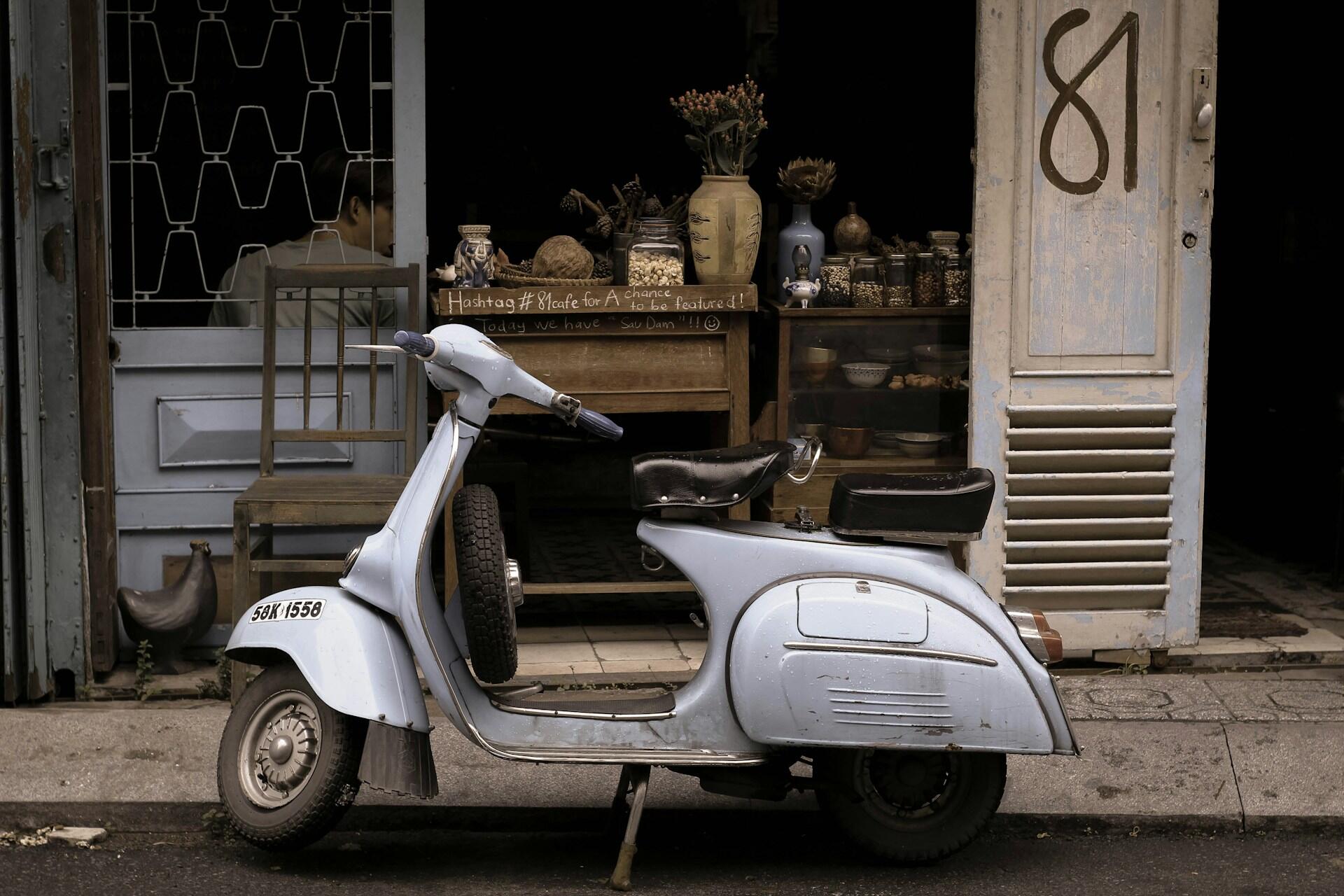 A moped parked in a street.