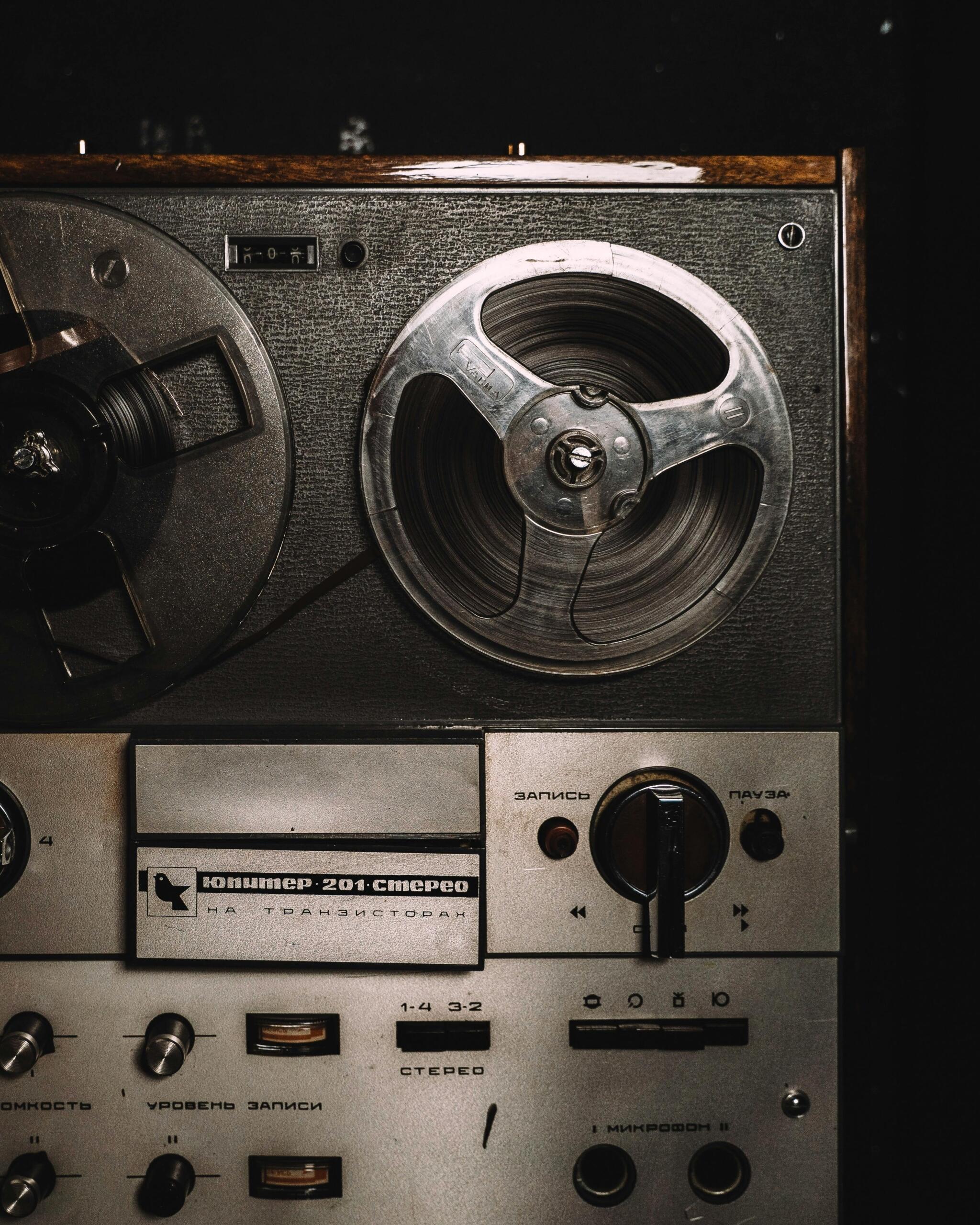 A black and silver cassette player with an old-school design, placed on a wooden surface.
