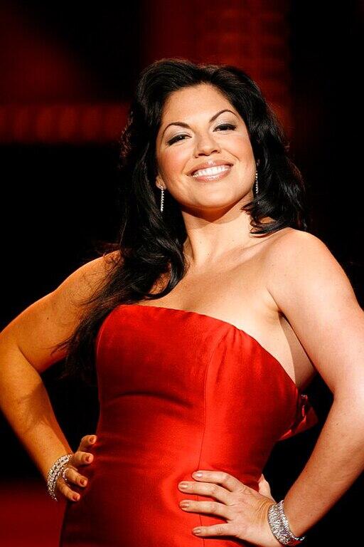 Sara Ramirez posing in a red dress.