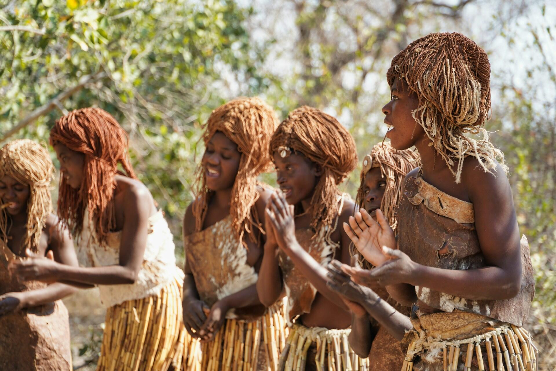 A group of women dancing in traditional African costumes.