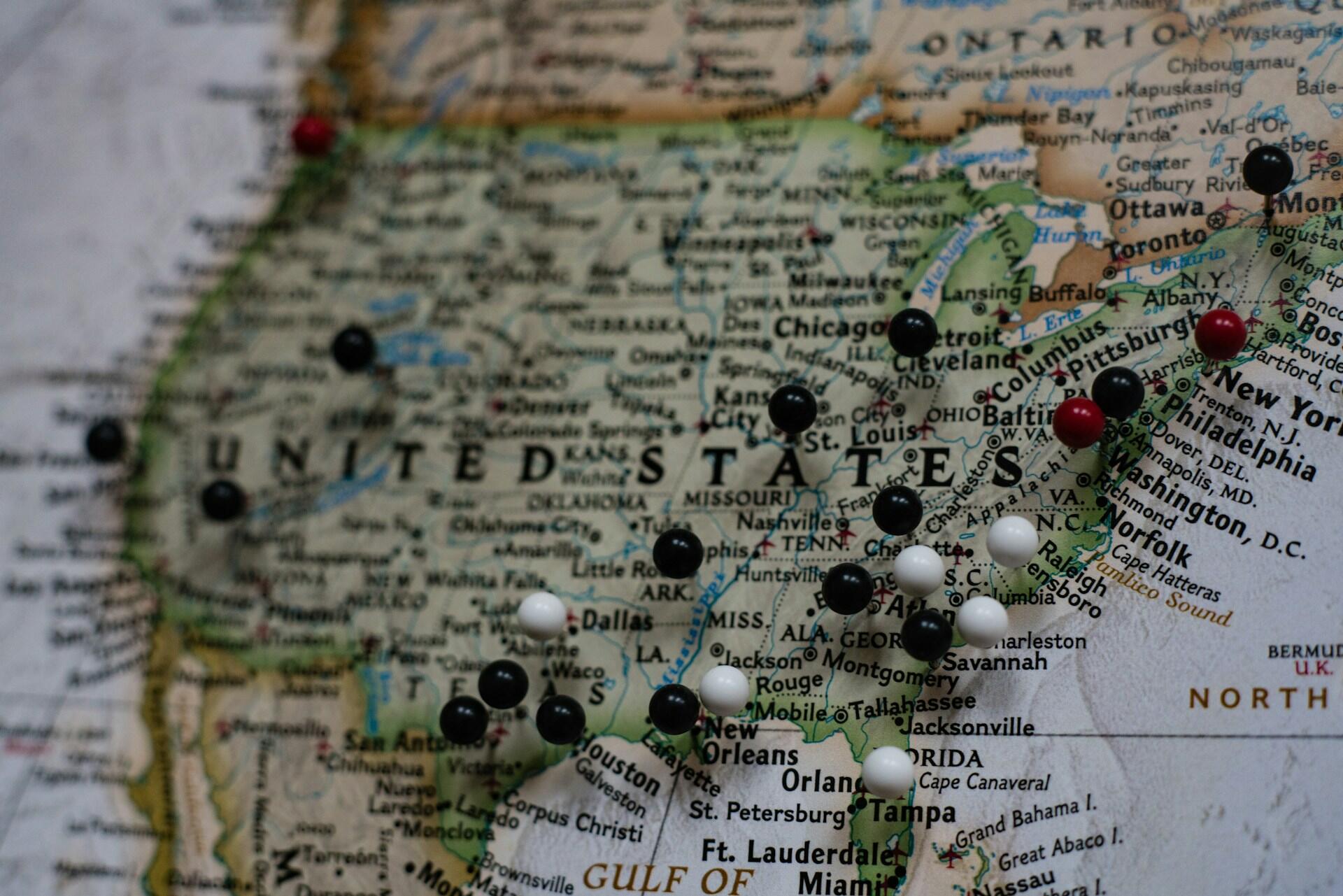 map of the United States with pins poked into different areas