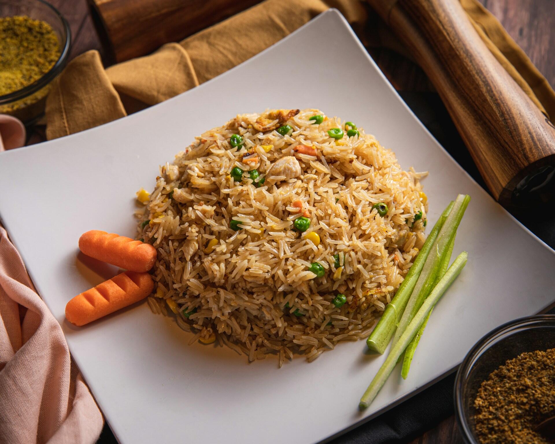 Fried rice with celery and carrots on the side.