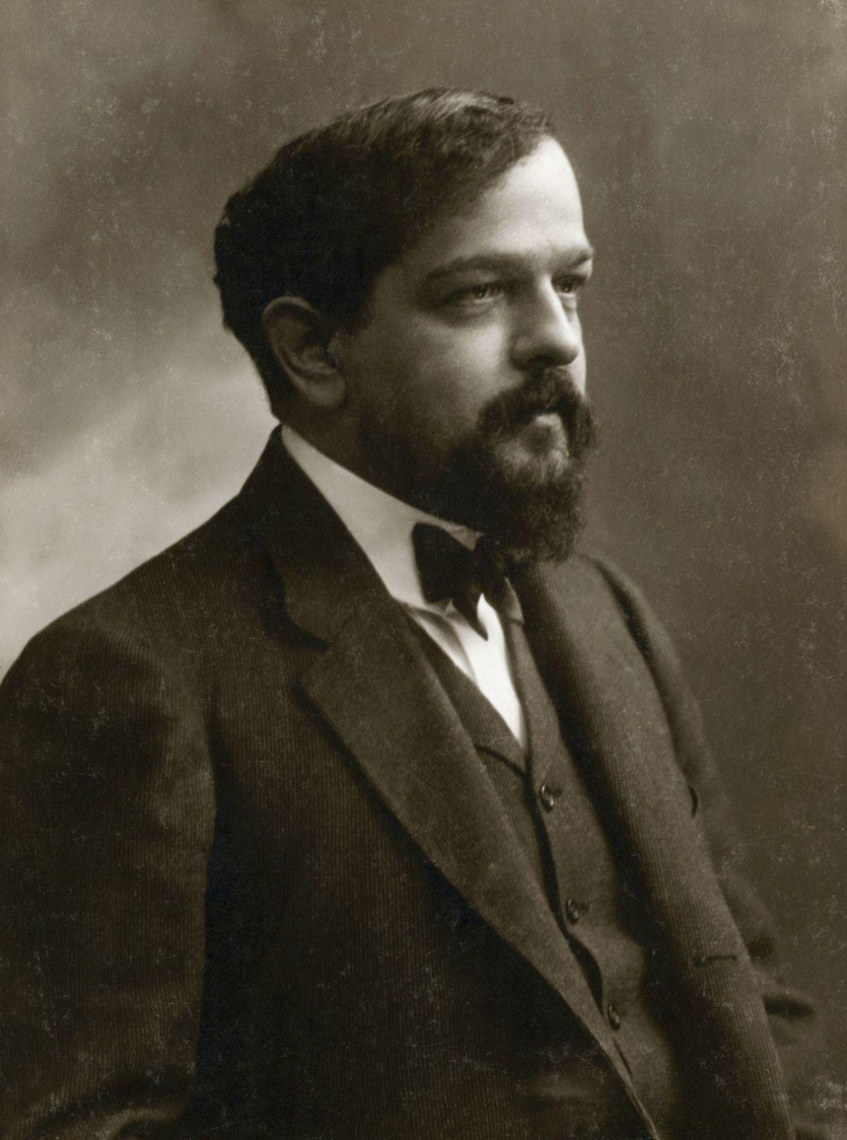 A black and white portrait of Claude Debussy.