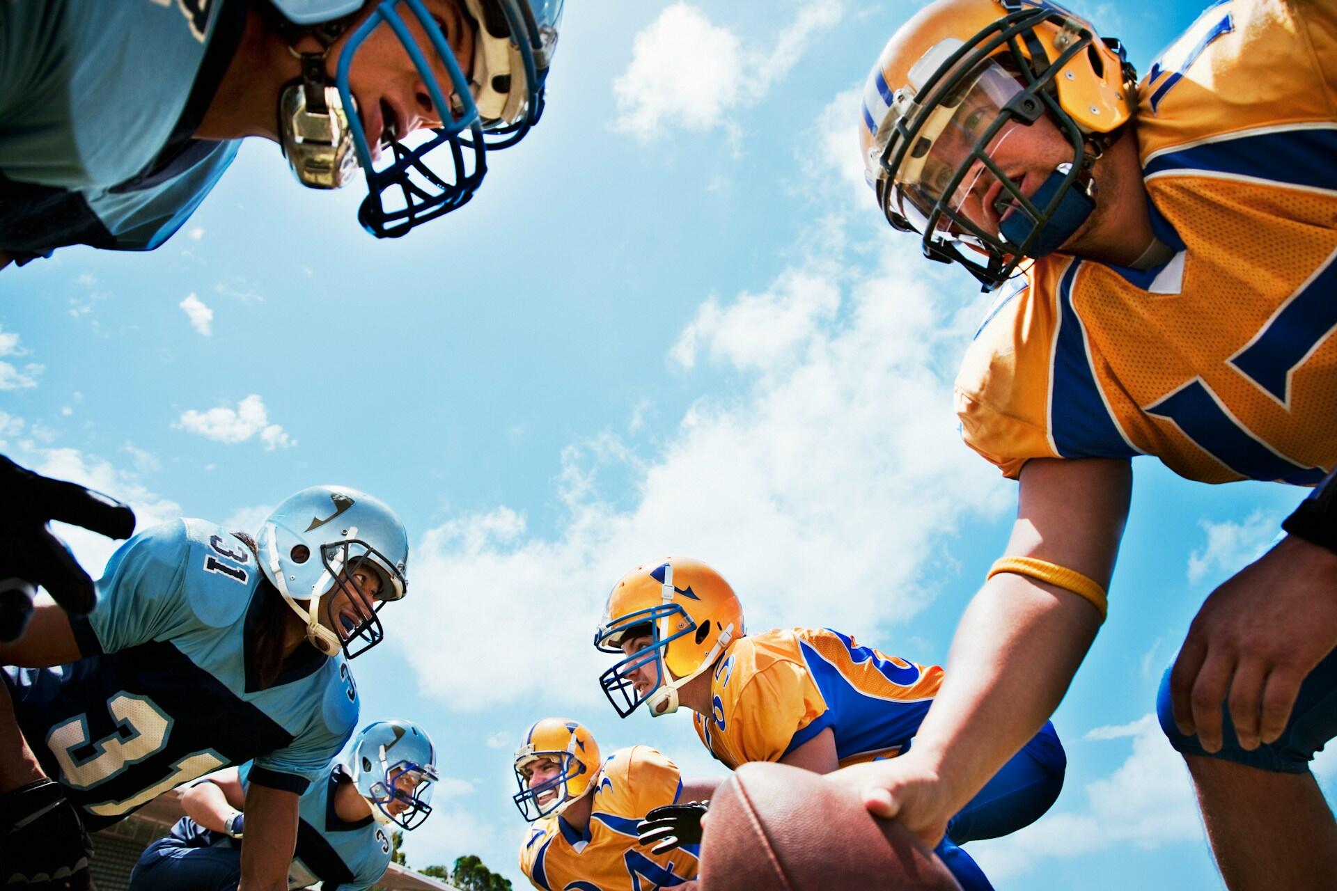 Two football teams preparing for a hike in a game.