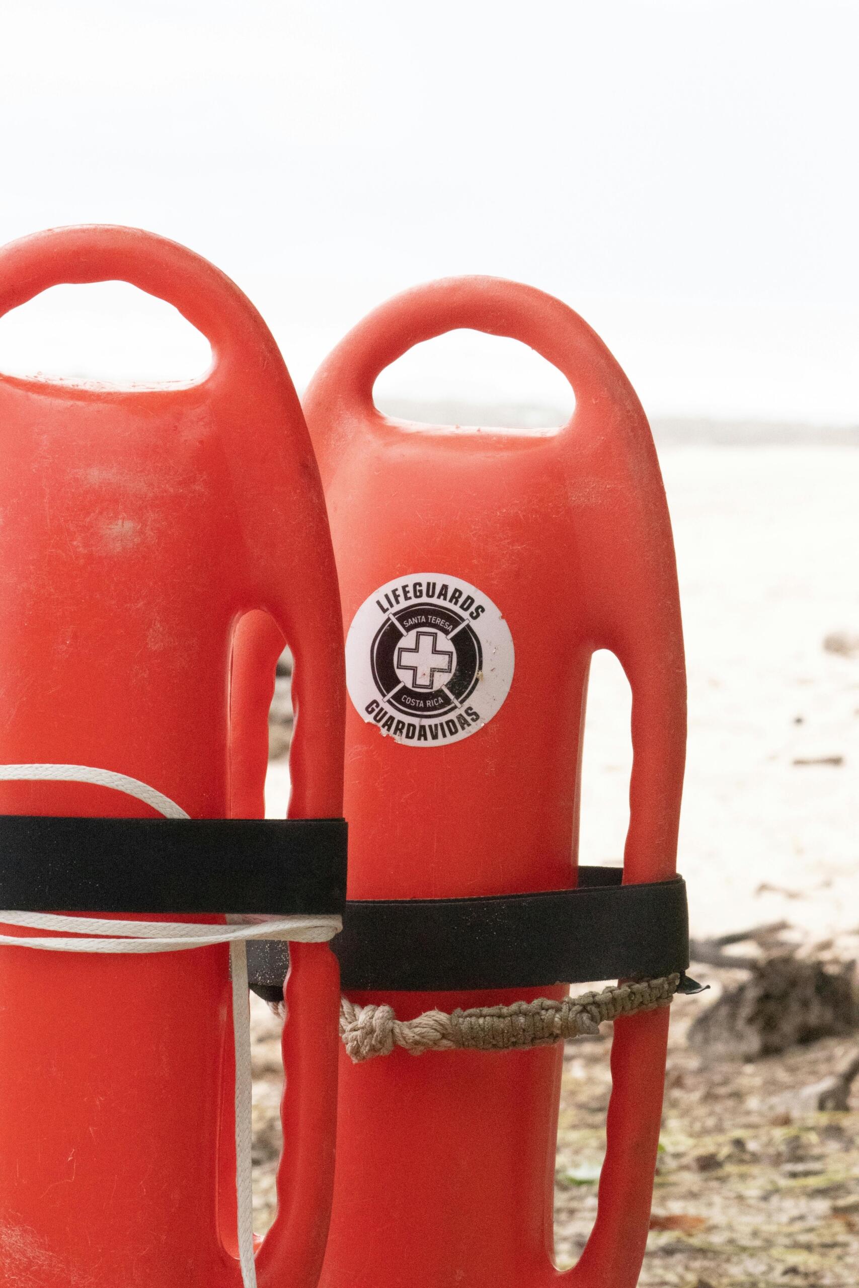 Close-up of red torpedo buoys stacked together.