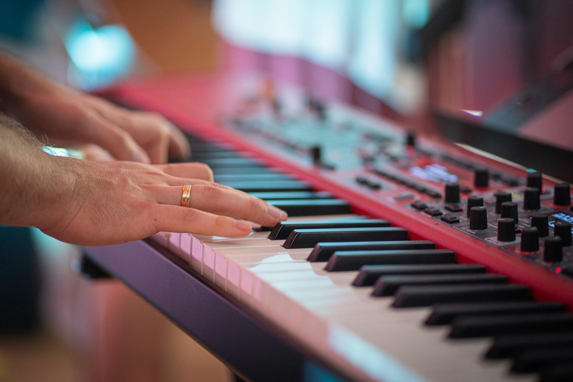 A pianist playing a digital piano.