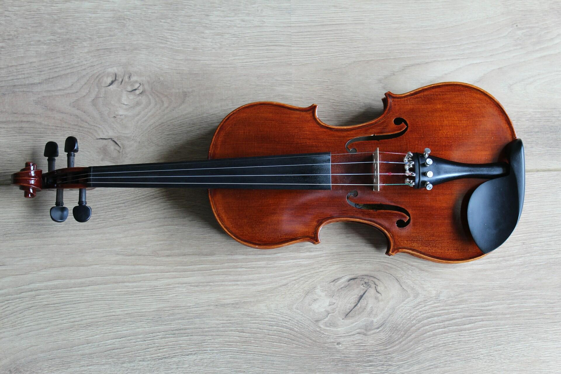 A violin lying sideways on a surface.