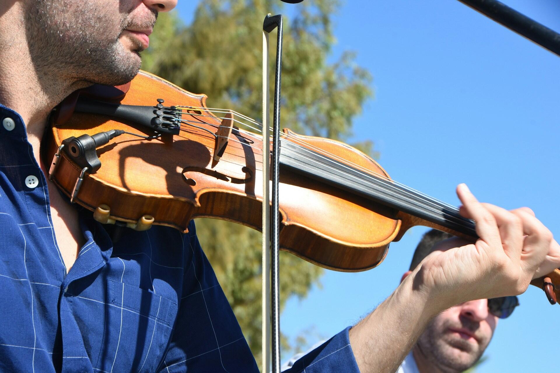 A violinist playing outside.