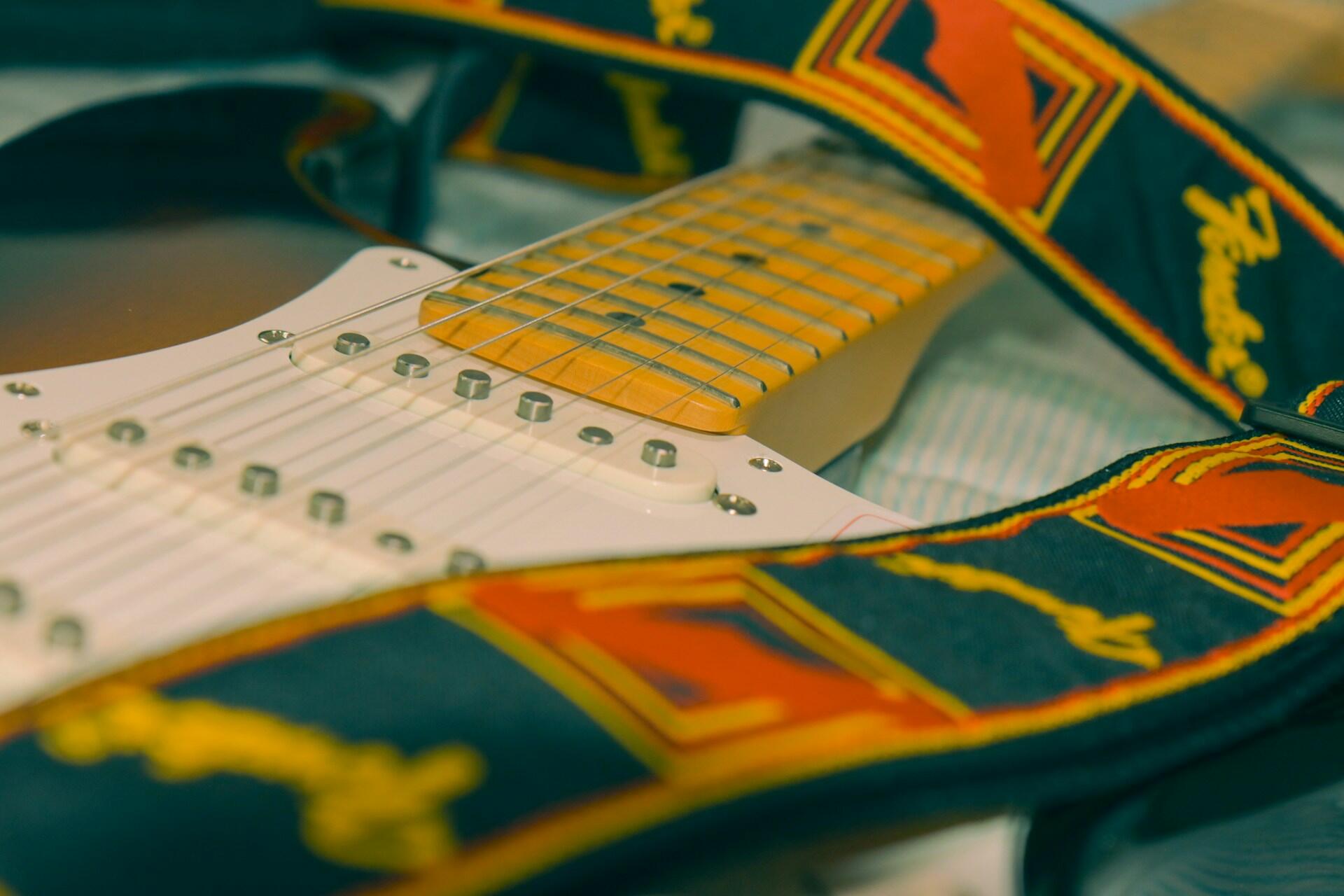 A closeup of a Fender Stratocaster guitar.