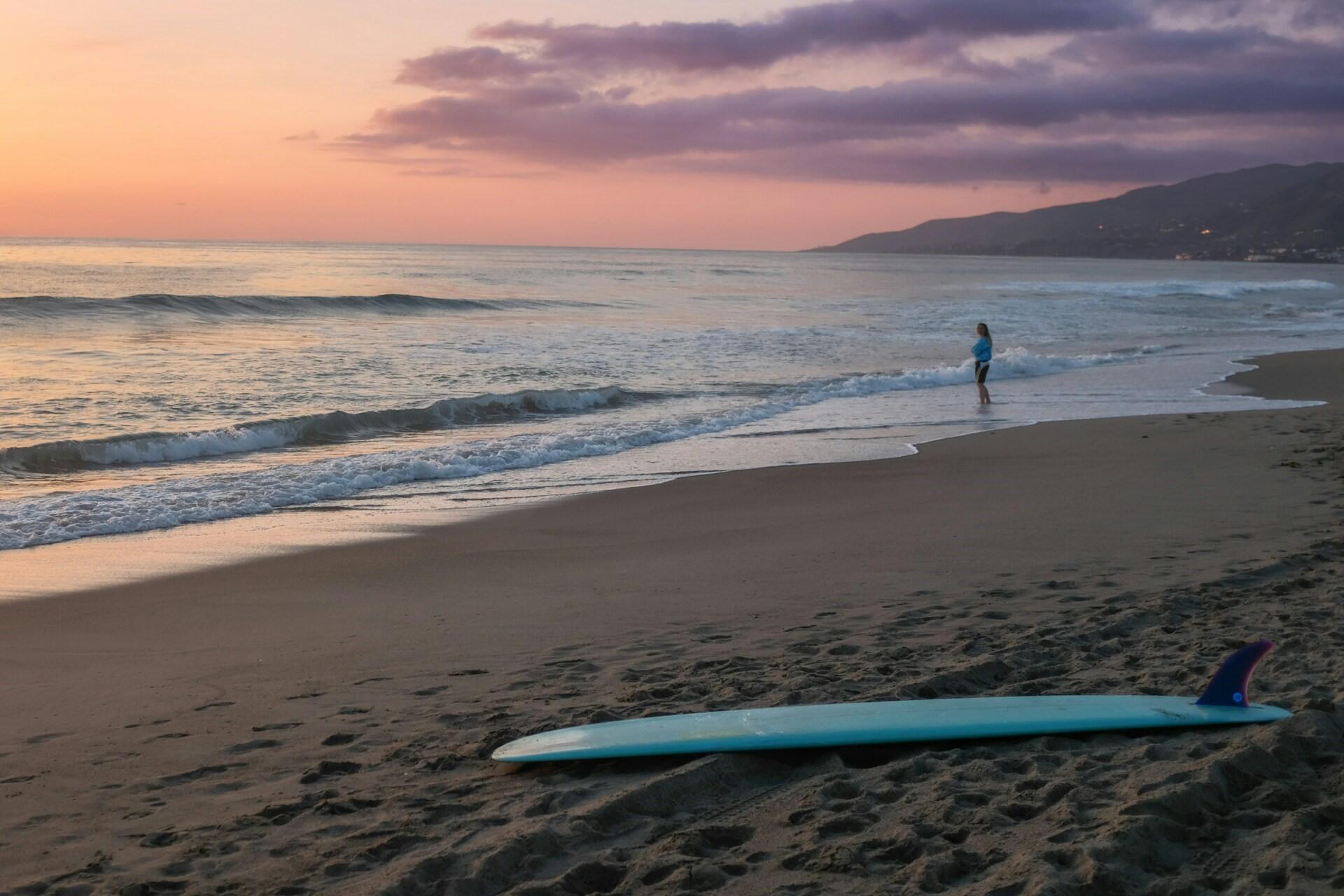 A beach in California with a surfboard.