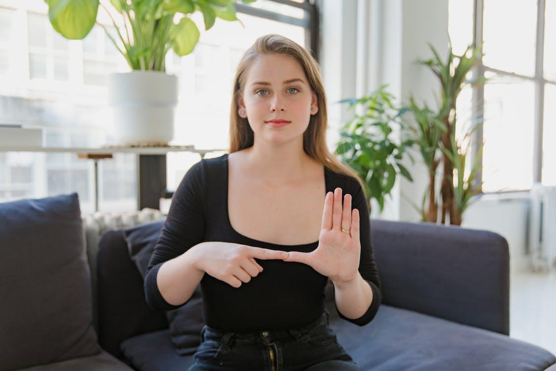 A woman expressing her emotions through sign language.