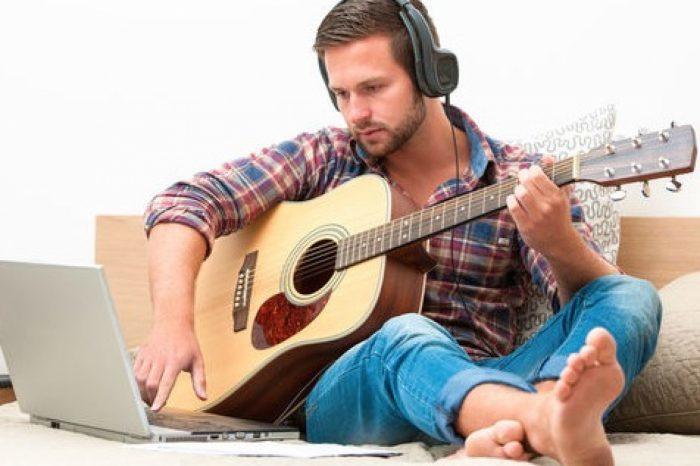 A man learning the guitar online