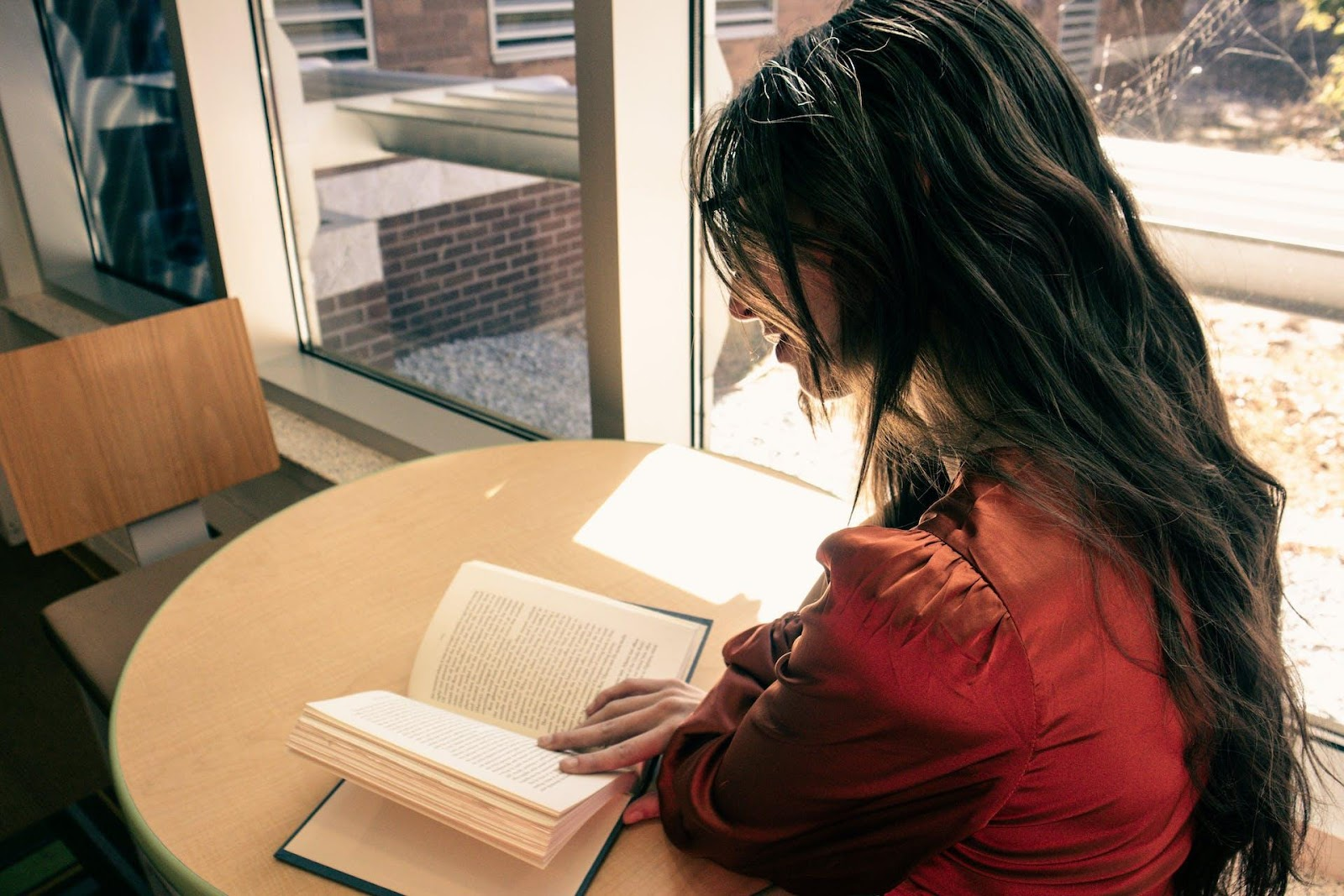 A girl is reading at the library.