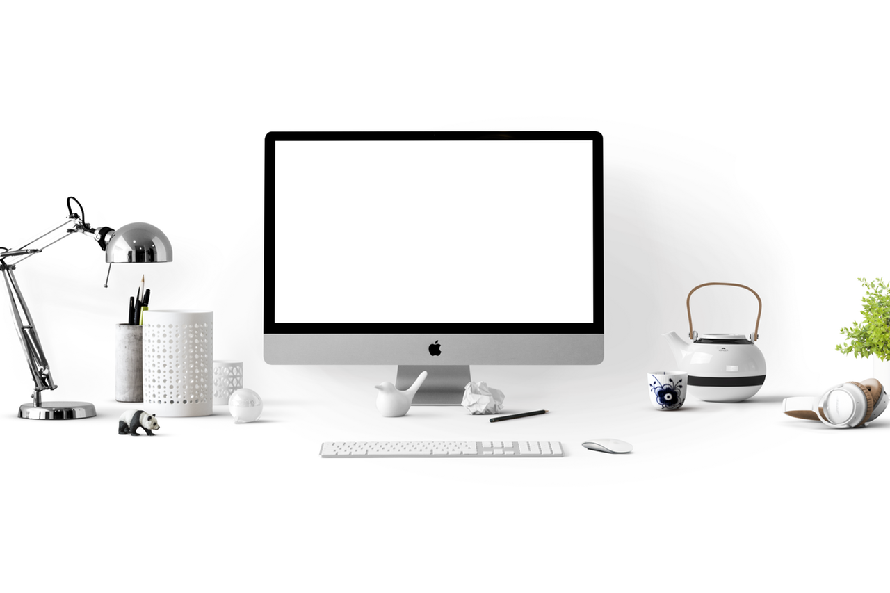 A computer and desk with little trinkets.