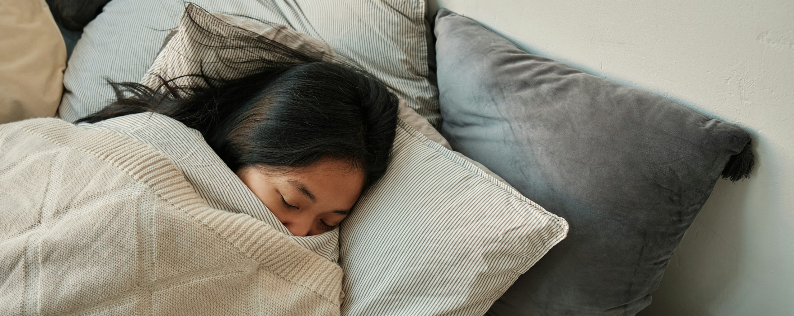 A girl sleeping under the covers