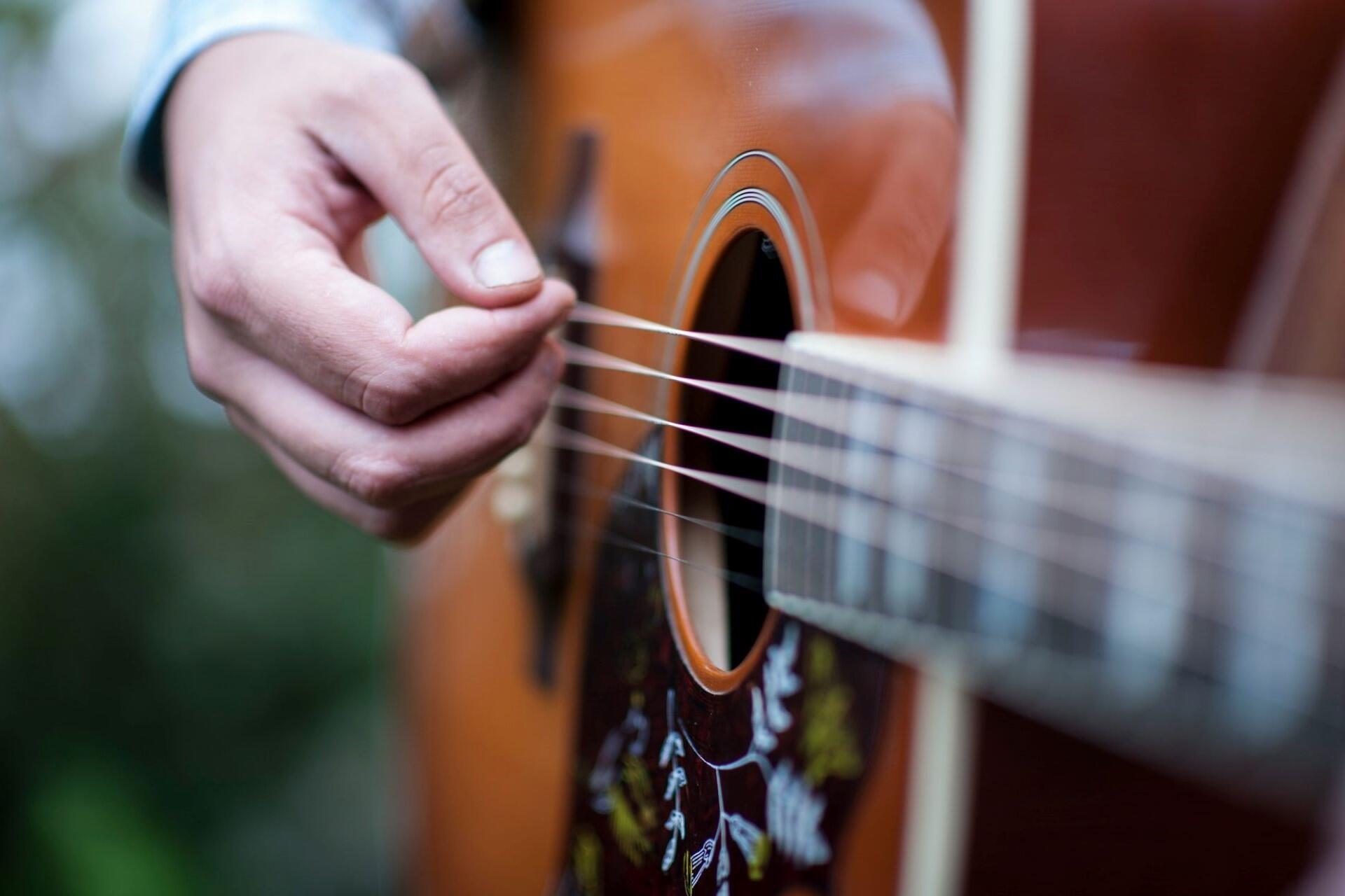 A country musician playing an acoustic guitar.