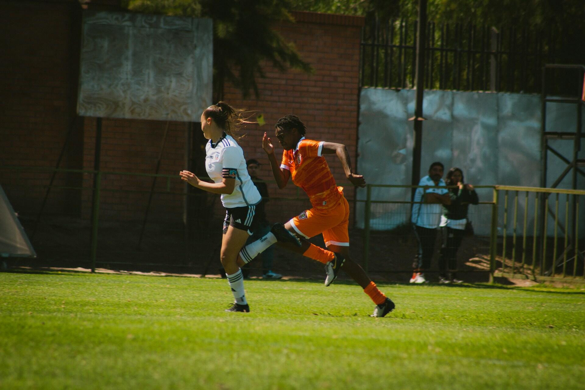 women playing soccer.