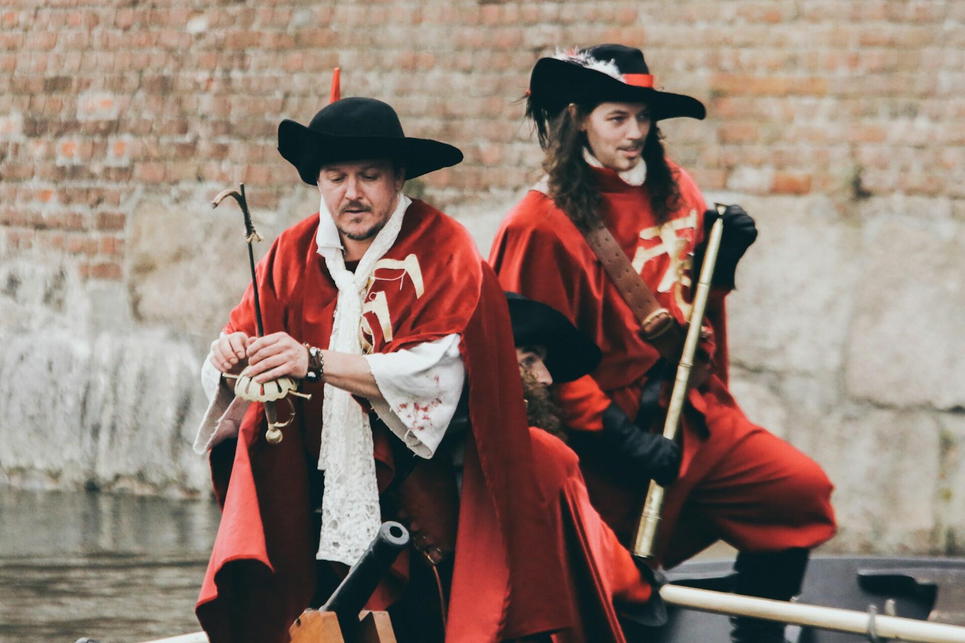 Actors dressed as musketeers.