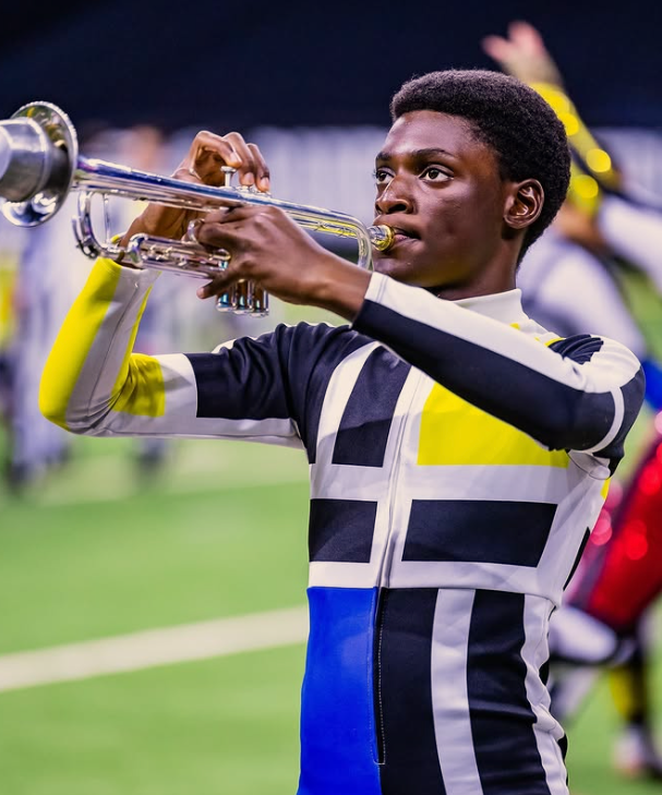 a student from Avon High School performing in the Mondriesque show with a zip-up coverall-style costume featuring a Mondrian-style pattern