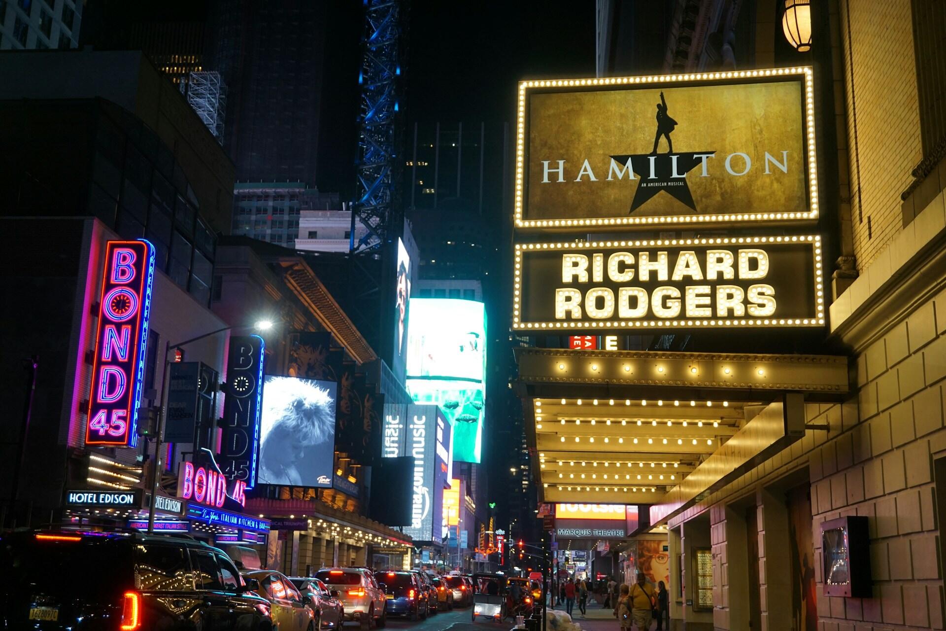 Broadway in New York City with a sign for Hamilton.