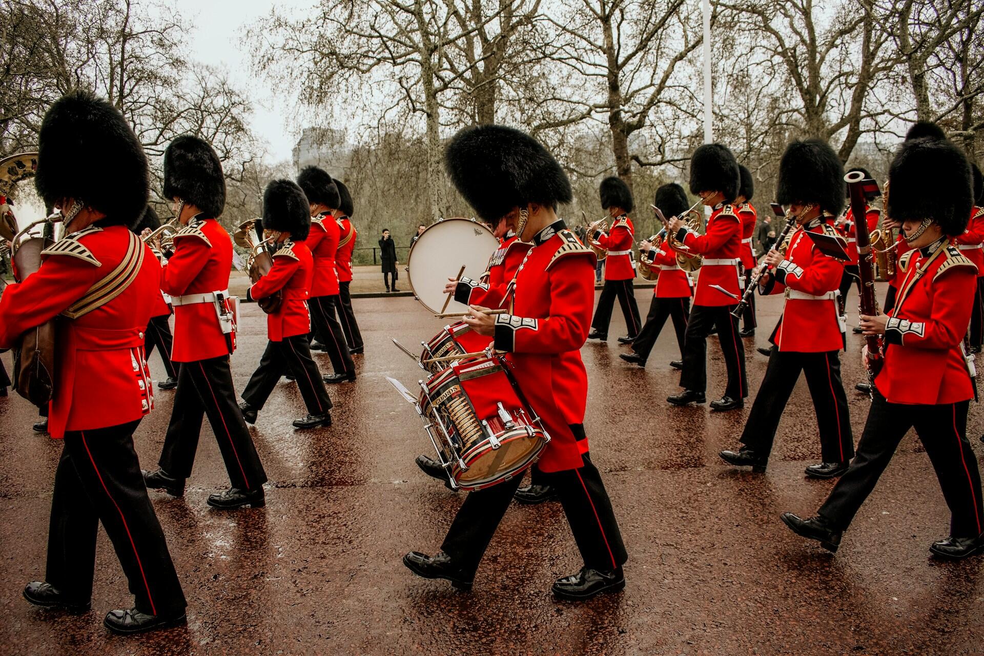 the British guard band drumline with the brass section behind
