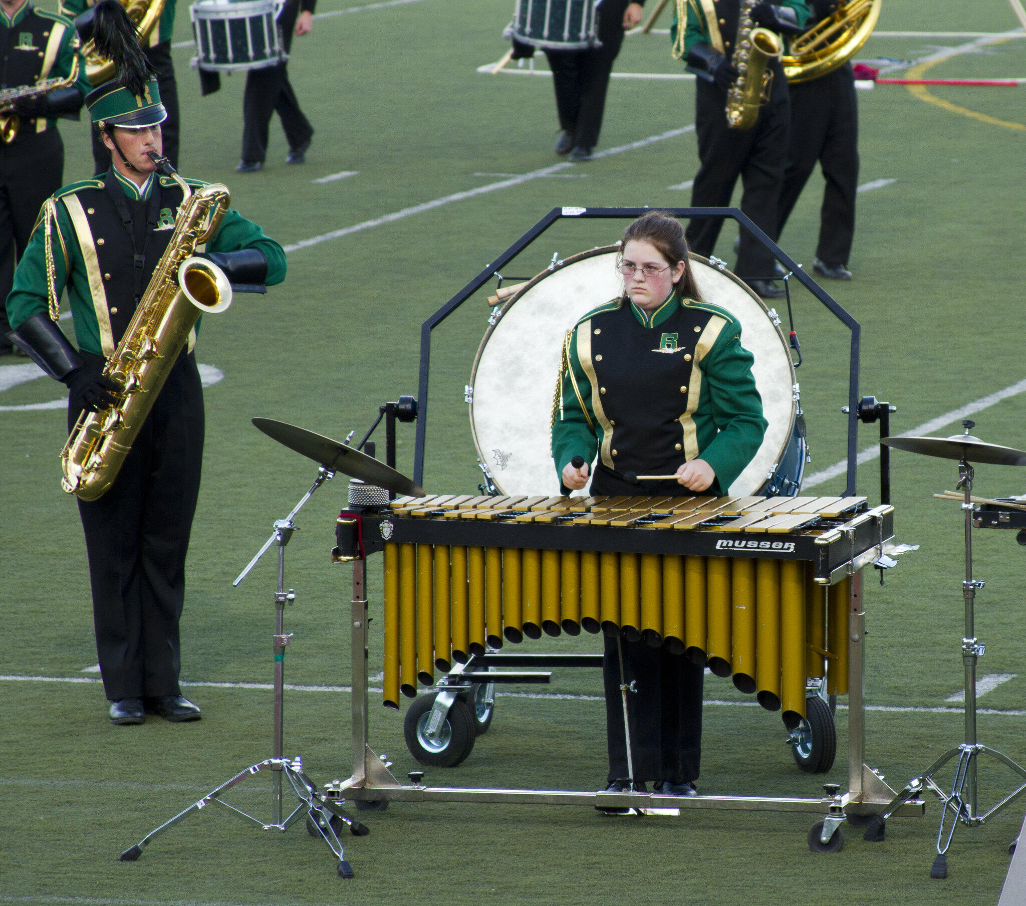 a marimba playing in the front ensemble near a saxophone player