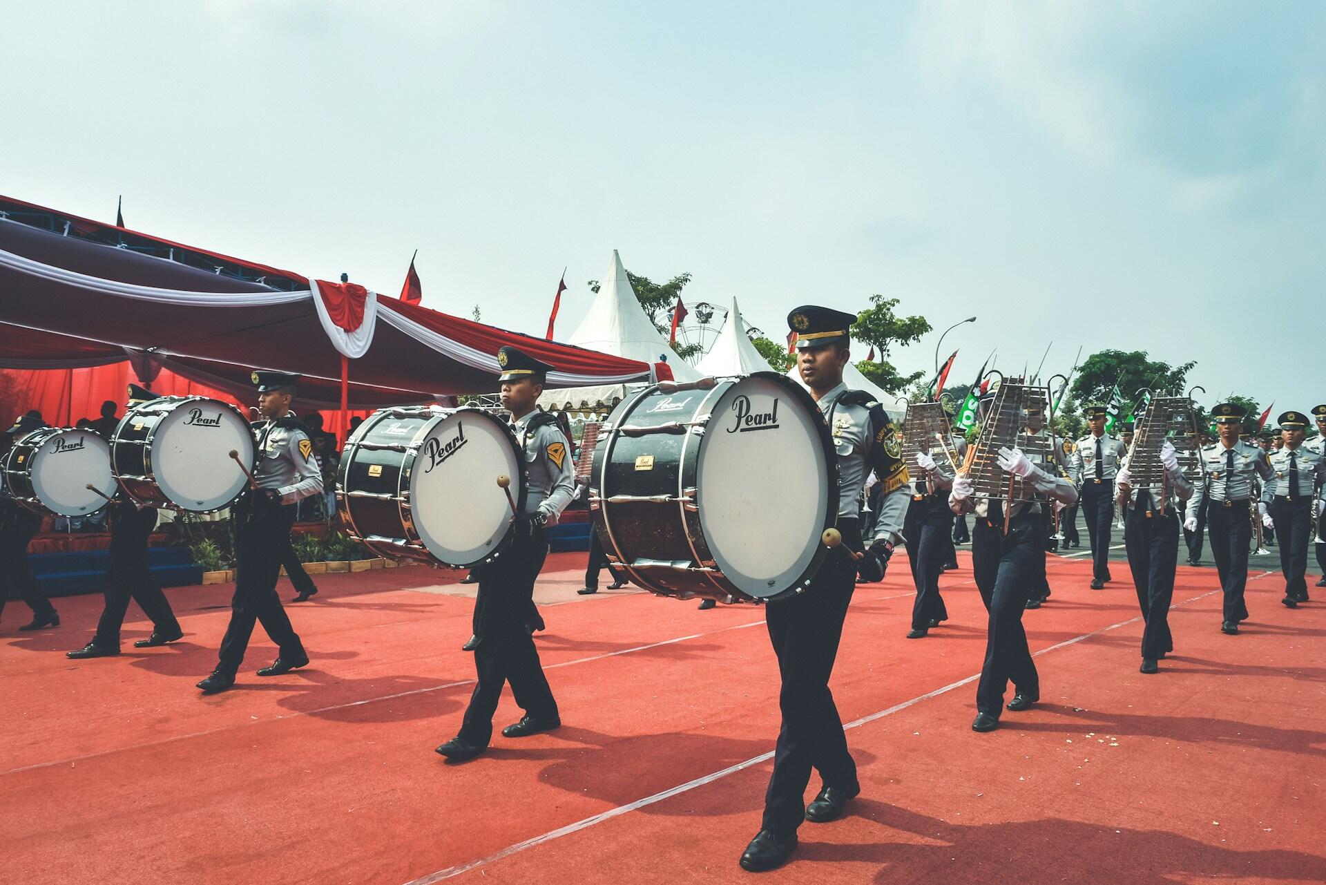 marching band players with bass drums and glockenspiels