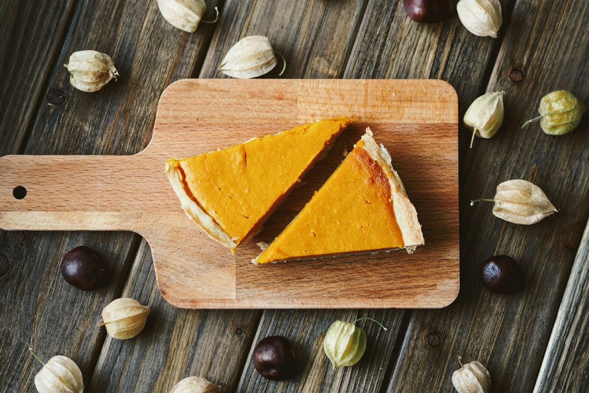 A pumpkin pie on a chopping board.