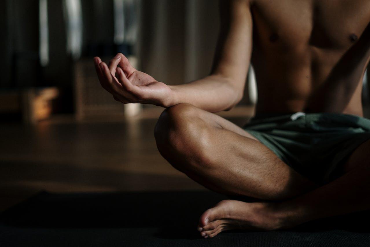 A man sitting in a meditation position.