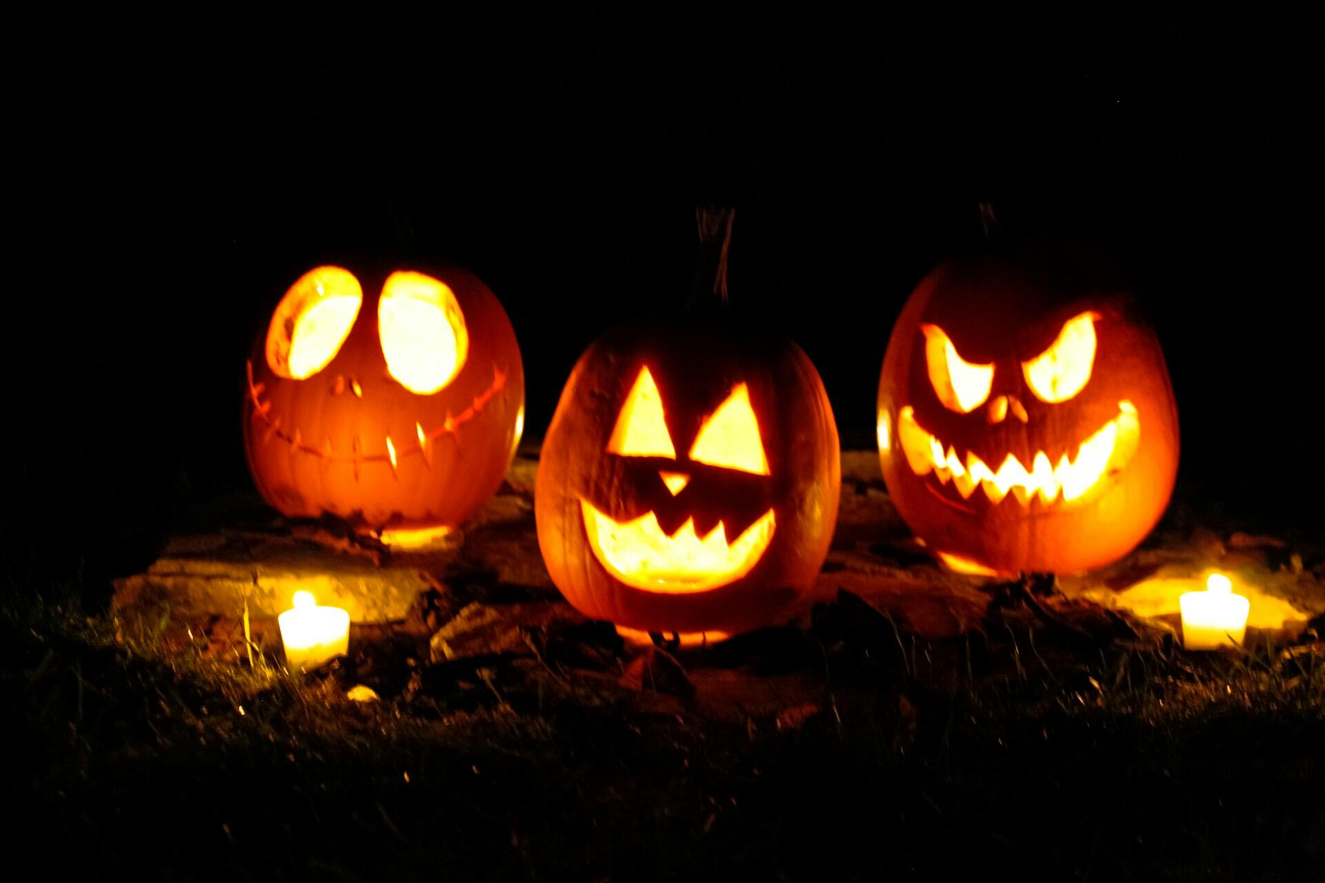 Three Halloween pumpkins with scary smiles.