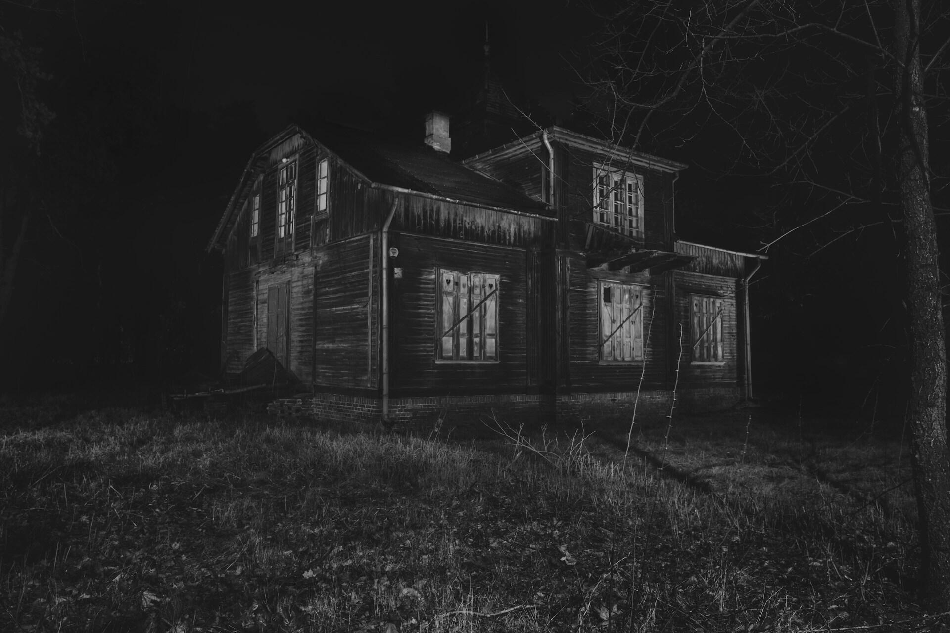 A black and white photo of a haunted mansion.