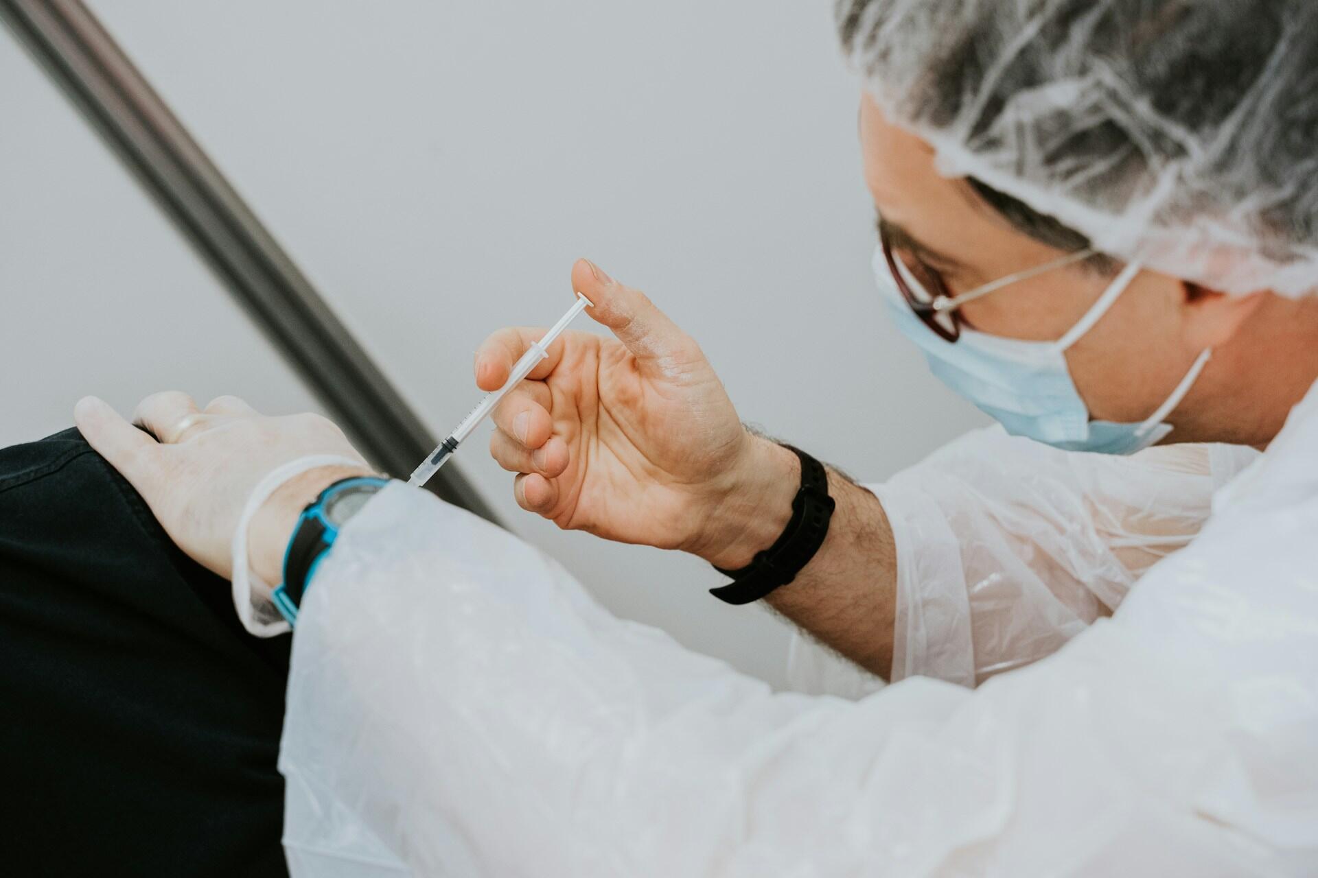 A nurse administering an injection.