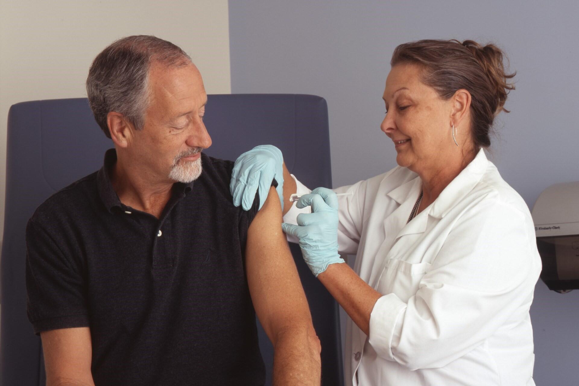 A nurse vaccinating someone.