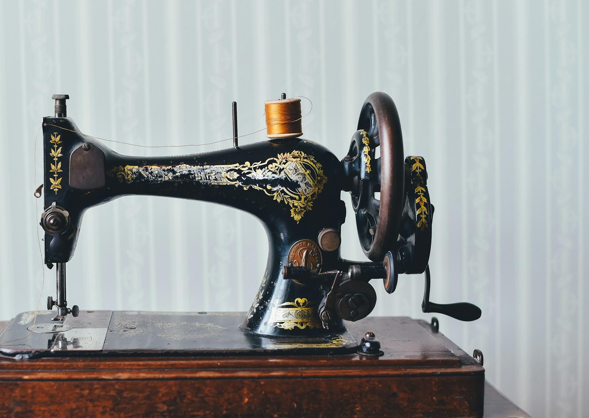 An old sewing machine with engravings on it.
