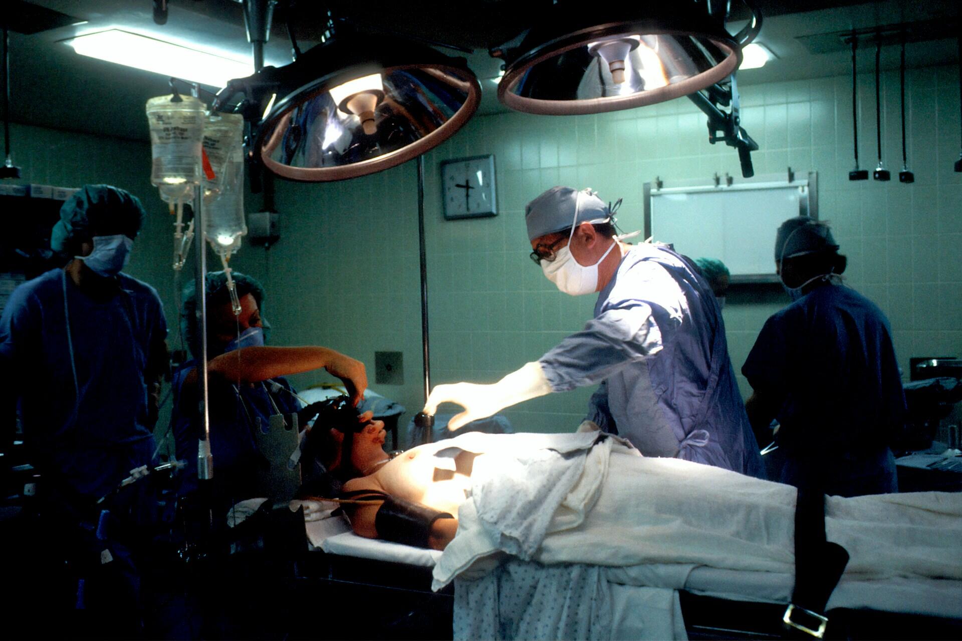 People working inside an operating theater.