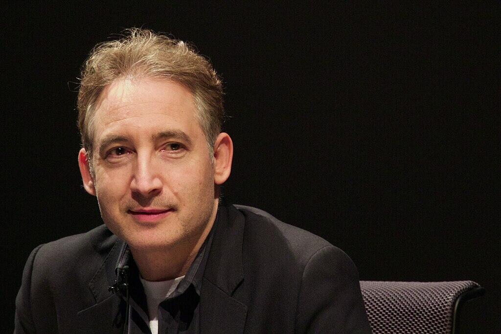 Brian Greene sitting at an event.