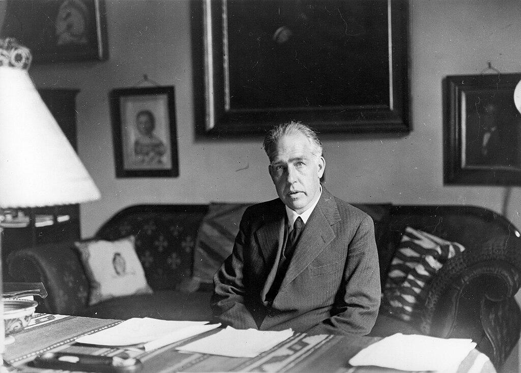 Niels Bohr sitting at his desk.